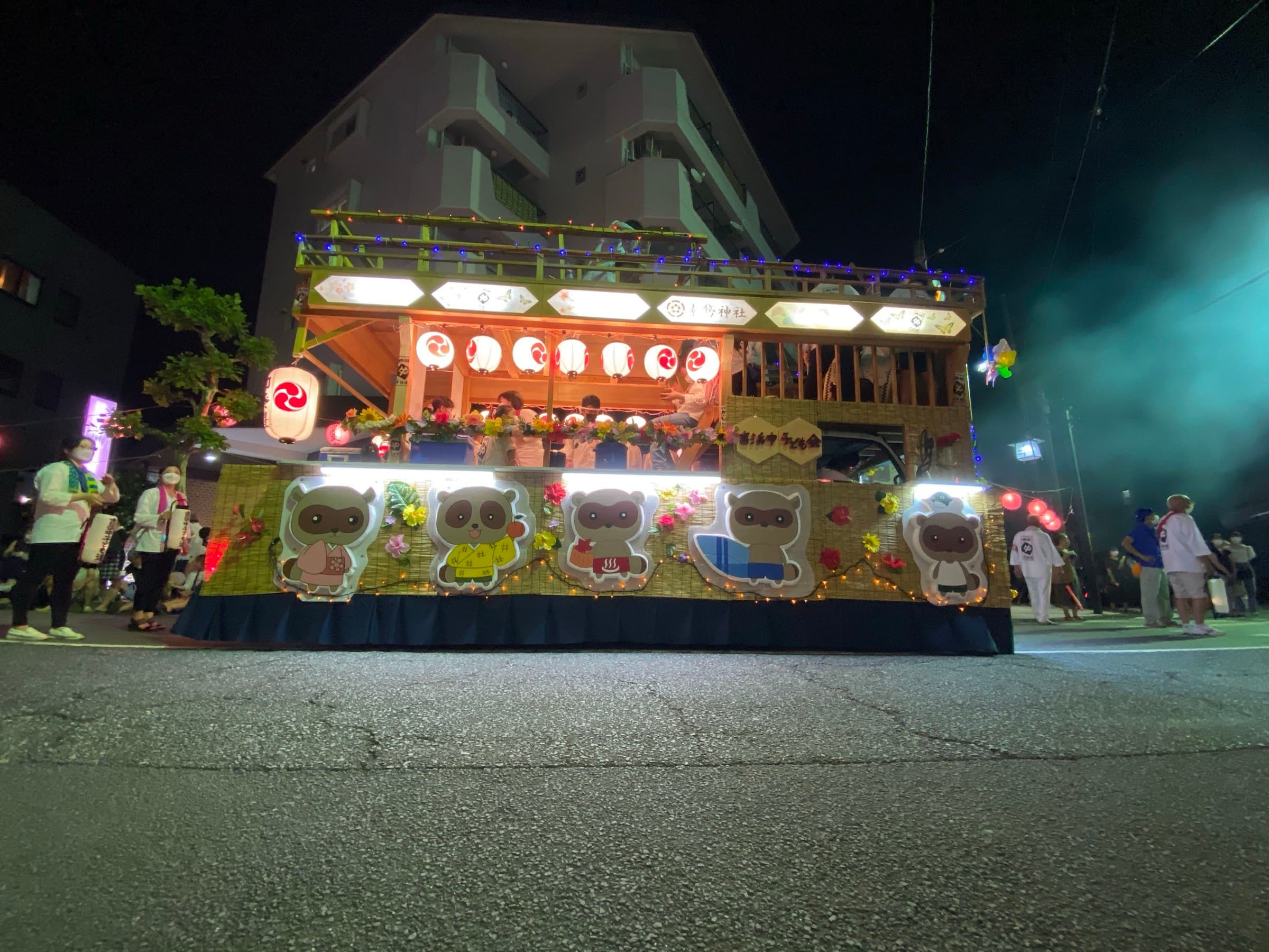 Yugawara festival float with lantern-lit mascots at night