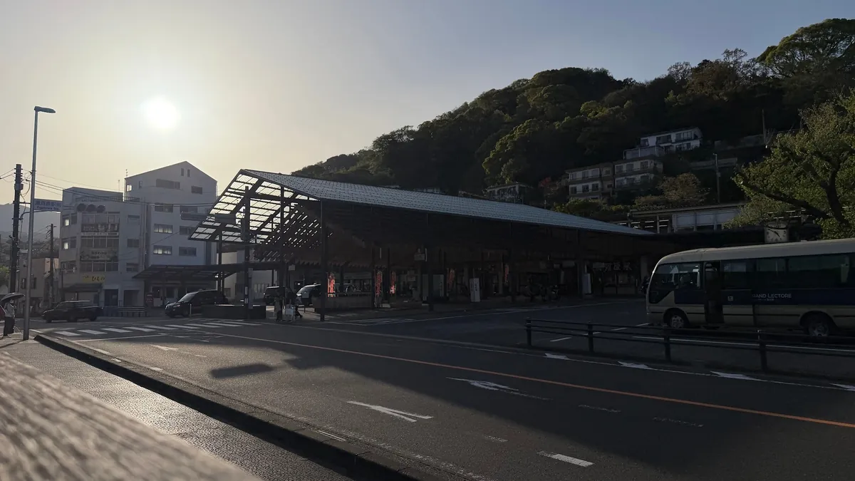 Yugawara Station and a bus outside in the sunshine