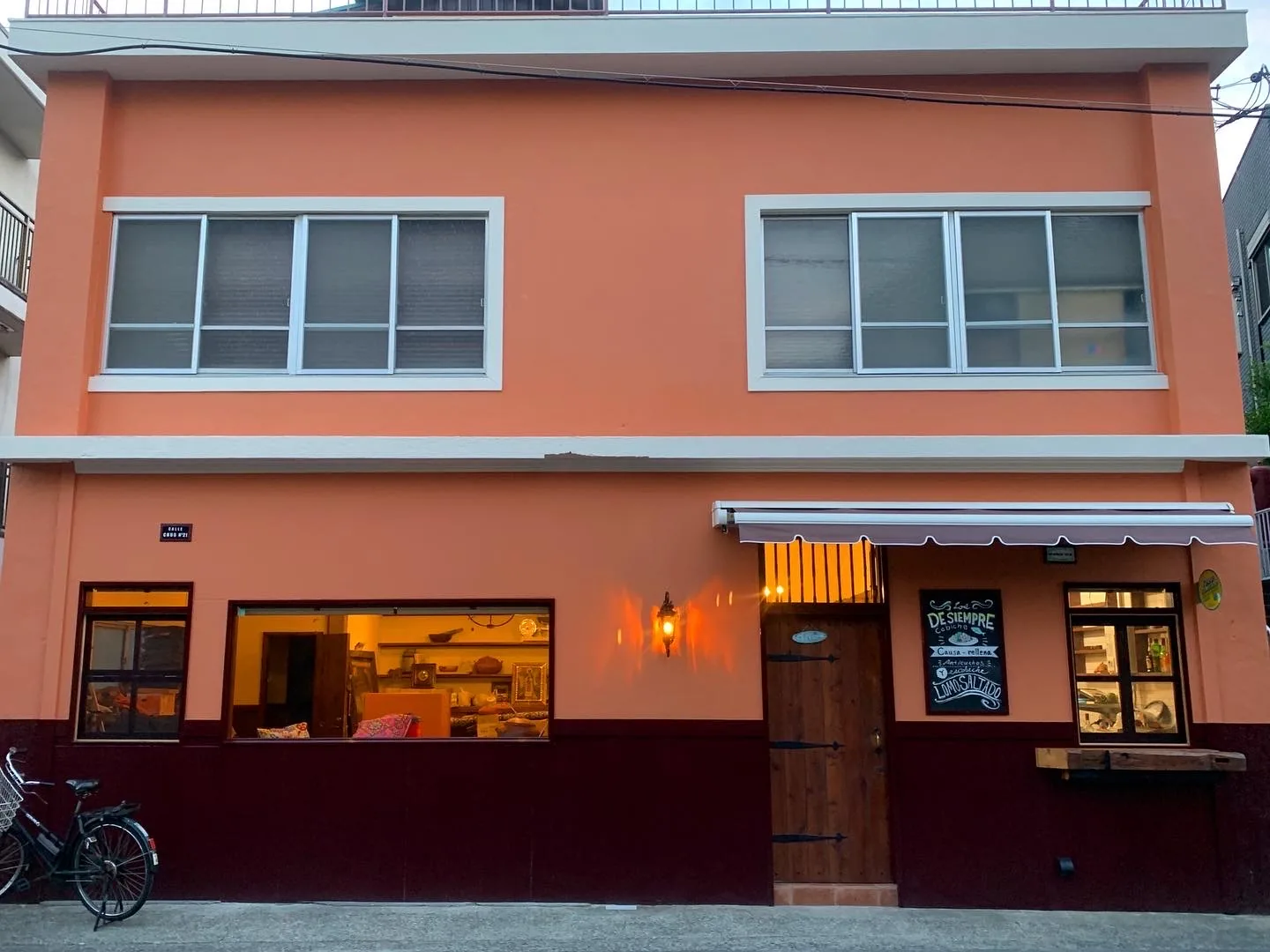 The orange two-storey shopfront of Arai Shoten